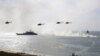 FILE - Russian navy ships and helicopters take a part in a landing operation during military drills at Crimea's Black Sea coast, Sept. 9, 2016.