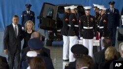 President Barack Obama and Secretary of State Hillary Rodham Clinton walk back to their seats after speaking during the Transfer of Remains Ceremony at Andrews Air Force Base in Maryland, September 14, 2012.