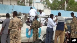 This image made from video shows the scene following a bomb attack on a van carrying U.N. employees in Garowe, in the semiautonomous Puntland region of northern Somalia, April 20, 2015. 