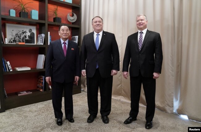 U.S. Secretary of State Mike Pompeo poses with Vice Chairman of the North Korean Workers' Party Committee Kim Yong Chol, North Korea's lead negotiator in nuclear diplomacy with the United States, and U.S. Special Representative for North Korea Stephen Biegun as they start talks aimed at clearing the way for a second U.S.-North Korea summit at a hotel in Washington, Jan. 18, 2019.