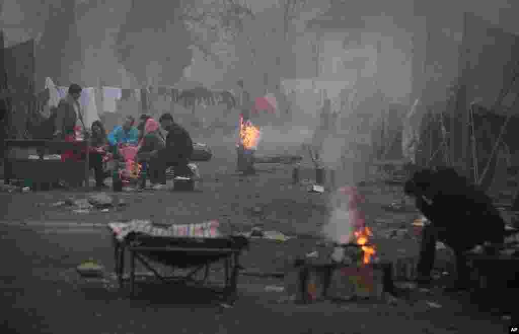 Syrian refugees try to stay warm near open fires in front of their unheated tents in a refugee camp in the town of Harmanli, Bulgaria, Thursday, Nov. 21, 2013. 