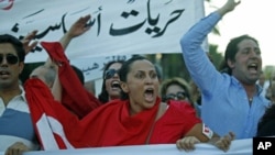 People chant slogans during a demonstration held after a group of individuals attacked the CinemAfricArt building to protest a controversial film called 'No God, No Master,' in Tunis, July 7, 2011