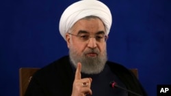 FILE - Iranian President Hassan Rouhani gives a press conference in Tehran, Iran, May 22, 2017. 