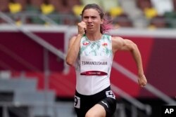 Krystsina Tsimanouskaya, of Belarus, runs in the women's 100-meter run at the 2020 Summer Olympics, Japan. (AP Photo/Martin Meissner, File)