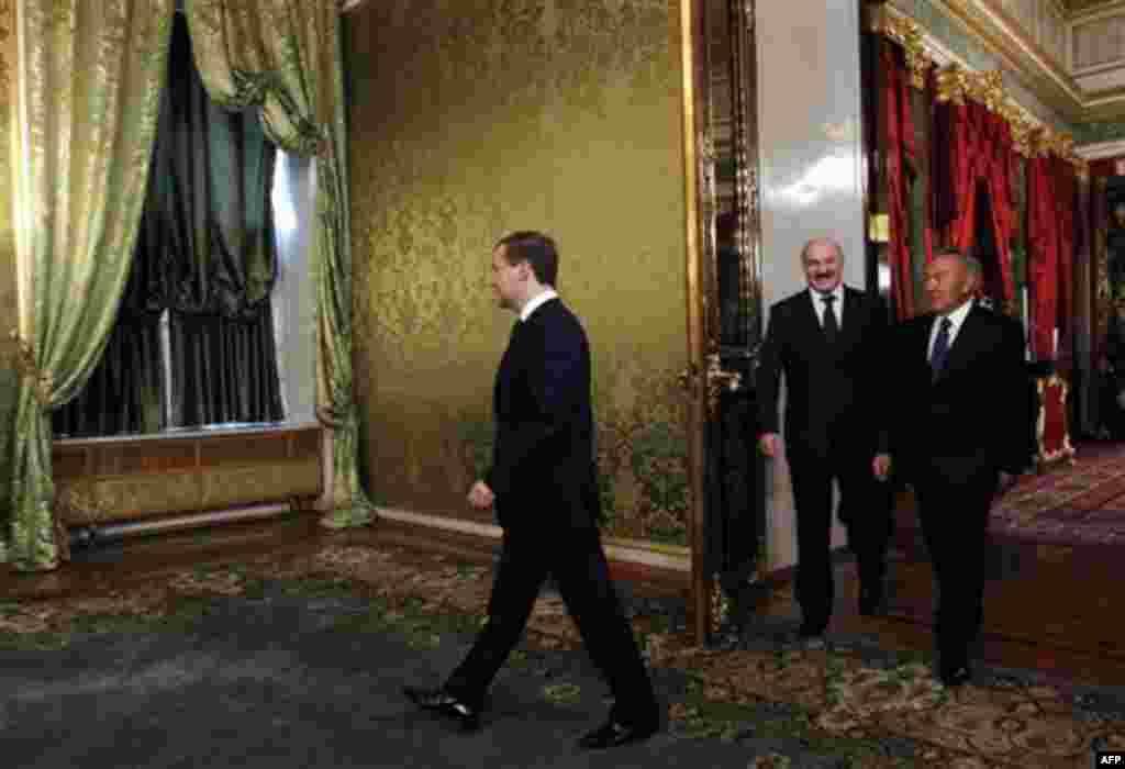 Russian President Dmitry Medvedev, left, enters as Belarusian President Alexander Lukashenko and Kazakhstan's President Nursultan Nazarbayev, right, follow him during the meeting of heads of states of the Supreme Eurasian Economic Council, in the Moscow K