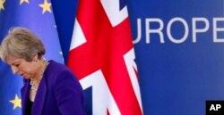FILE - British Prime Minister Theresa May walks off the podium after a media conference during an EU summit in Brussels, Oct. 18, 2018.