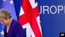 British Prime Minister Theresa May walks off the podium after a media conference during an EU summit in Brussels, Oct. 18, 2018. EU leaders met to discuss migration, cybersecurity and to try and move ahead on stalled Brexit talks.