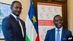 CAR Foreign Minister Charles Armel Doubane, right, and Armel Mingatoloum Sayo, head of the Revolution and Justice militia, mark the signing of a Central African Republic peace accord at the Sant'Egidio headquarters in Rome, June 19, 2017. Members of 13 Central African Republic's militant groups signed a preliminary agreement to stop the civil war, reaffirm the unity of the country, and the respect of human and civil rights.