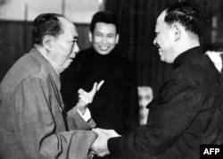 FILE - A photo taken in the 1970 outside of Cambodia, shows China's chairman Mao Ze Dong, left, greeting top Khmer Rouge official Ieng Sary, right, also known as " brother number three," while Khmer Rouge leader Pol Pot, center, looks on.