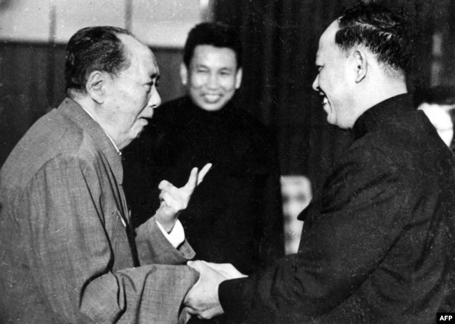 FILE - A photo taken in the 1970 outside of Cambodia, shows China's chairman Mao Ze Dong, left, greeting top Khmer Rouge official Ieng Sary, right, also known as " brother number three," while Khmer Rouge leader Pol Pot, center, looks on.