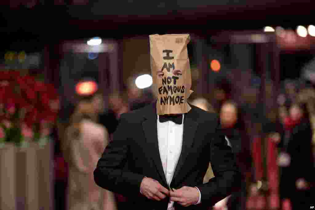 Actor Shia LaBeouf poses for photographers, with a paper bag over his head that says 'I am not famous anymore,' on the red carpet for the film "Nymphomaniac" at the International Film Festival Berlinale in Berlin.