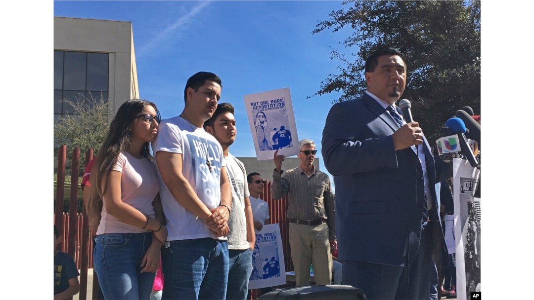 The family of Guadalupe Garcia de Rayos stands behind her attorney, Ray Ybarra Maldonado, as he speaks in front of the U.S. Immigration and Customs Enforcement office in Phoenix. Garcia de Rayos was deported Feb. 9, 2017.