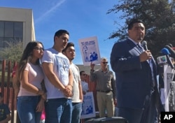 The family of Guadalupe Garcia de Rayos stands behind her attorney, Ray Ybarra Maldonado, as he speaks in front of the U.S. Immigration and Customs Enforcement office in Phoenix. Garcia de Rayos was deported Feb. 9, 2017.