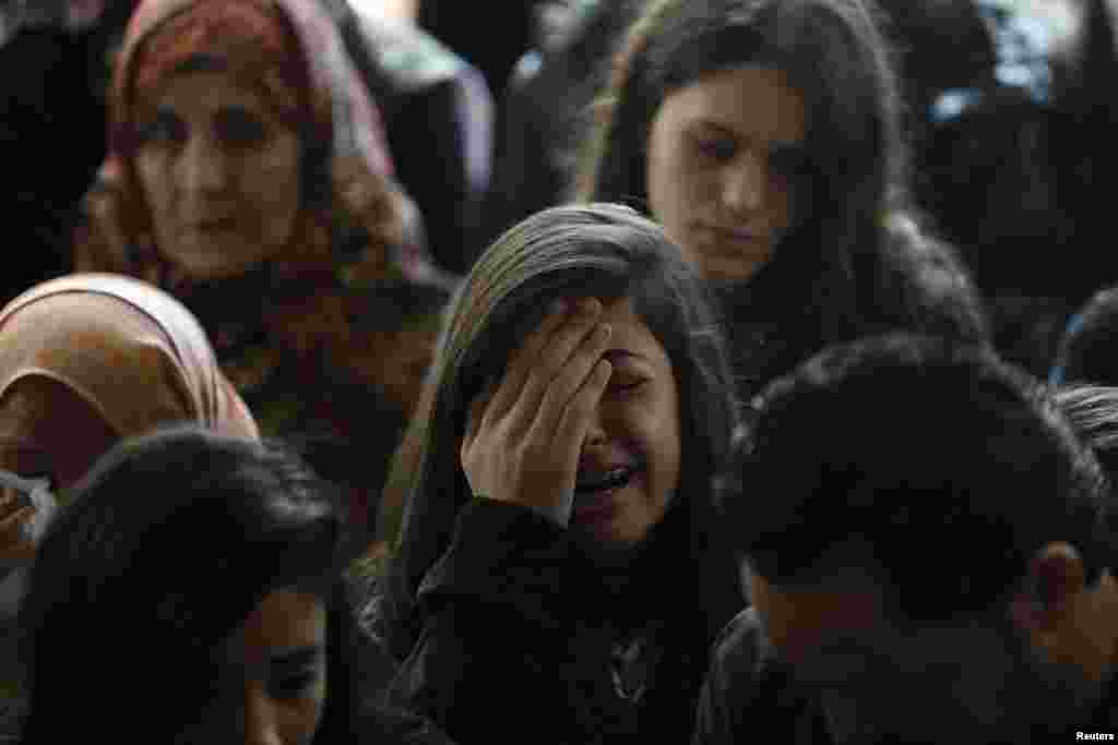 A relative of Palestinian Minister Ziad Abu Ein mourns during his funeral in Ramallah, West Bank, Dec. 11, 2014.