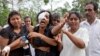 Anusha Kumari, center, weeps during a mass burial for her husband, two children and three siblings, all victims of Easter Sunday's bomb attacks, in Negombo, Sri Lanka, April 24, 2019.