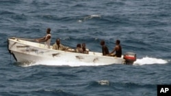 In this U.S. Navy photo, pirates leave the Ukrainian merchant vessel MV Faina for Somalia's shore Wednesday, Oct. 8, 2008 while under observation by a U.S. Navy ship. The MV Faina, which was carrying a cargo of Ukrainian T-72 tanks and related military eq