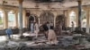 People view the damage inside of a mosque following a bombing in the provincial capital of Kunduz, northern Afghanistan, Oct. 8, 2021.