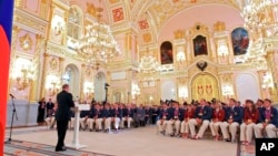 FILE - In this file photo taken on Tuesday, Sept. 11, 2012, President Vladimir Putin, foreground left, speaks as he meets with the national paralympic team after they returned from the Paralympic Games 2012 in London, in Moscow's Kremlin, Russia. The entire Russia team has been banned from competing in the Paralympic Games in September as punishment for the country's systematic doping program. 