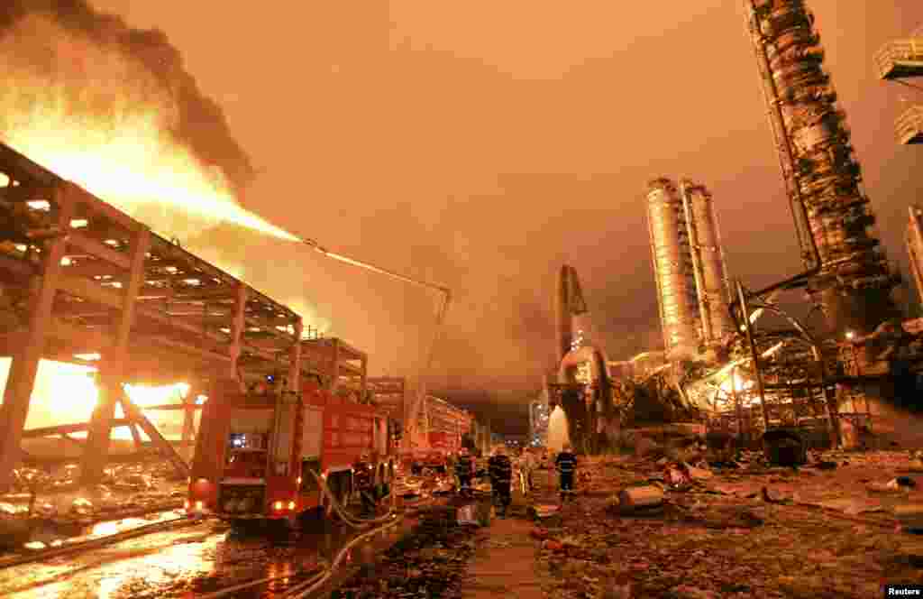 Firefighters try to put out a fire at a petrochemical plant in Zhangzhou, Fujian province, China. At least six people were injured after an explosion hit part of an oil storage facility at Dragon Aromatics, an independent petrochemical producer in eastern China, Xinhua reported.