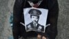 A man holds a picture of Chief Commissioner of the Malaysian Anti-Corruption Commission (MACC) Azam Baki during an Arrest Azam Baki rally in Kuala Lumpur on Jan. 22, 2022. 