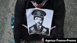 A man holds a picture of Chief Commissioner of the Malaysian Anti-Corruption Commission (MACC) Azam Baki during an Arrest Azam Baki rally in Kuala Lumpur on Jan. 22, 2022. 