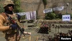 Pakistani soldier stands by ammunition seized during a military operation against Taliban militants, Miranshah, North Waziristan, July 9, 2014.