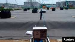 A leakage detective unit (C) and its detection punch unit on an underground water storage tank are seen at TEPCO's tsunami-crippled Fukushima nuclear power plant in Fukushima, in this undated photograph released by TEPCO on April 6, 2013.