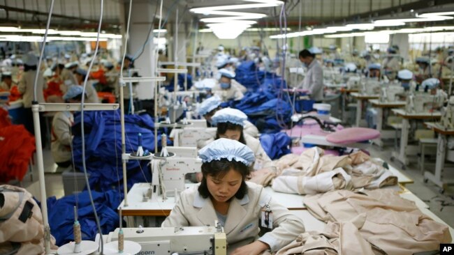 North Korean workers assemble jackets at a factory of a South Korean-owned company at the jointly-run Kaesong Industrial Complex, in Kaesong, North Korea, on Dec. 19, 2013.