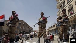 Former government soldiers stand guard as protesters demand President Saleh's resignation, Sana'a, Oct. 6, 2011.