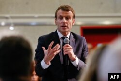 French President Emmanuel Macron gestures as he answers questions during a meeting with local residents as part of the "Great National Debate" in Bourg-de-Peage near Valence, Jan. 24, 2019.
