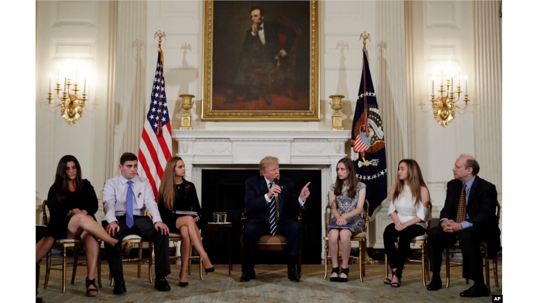 FILE - President Donald Trump speaks as he hosts a listening session with high school students, teachers and parents in the State Dining Room of the White House in Washington, Feb. 21, 2018.