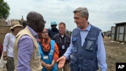 UNCHR High Commissioner Filippo Grandi, right, visits South Sudan's largest camp for the internally-displaced, in Bentiu, South Sudan Sunday, June 18, 2017.