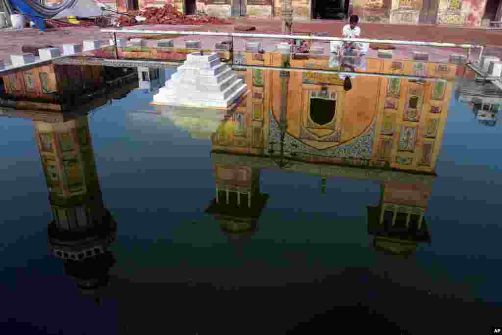 A Pakistani Muslim performs ablutions before evening prayer at historical Wazir Khan mosque in Lahore, Pakistan.