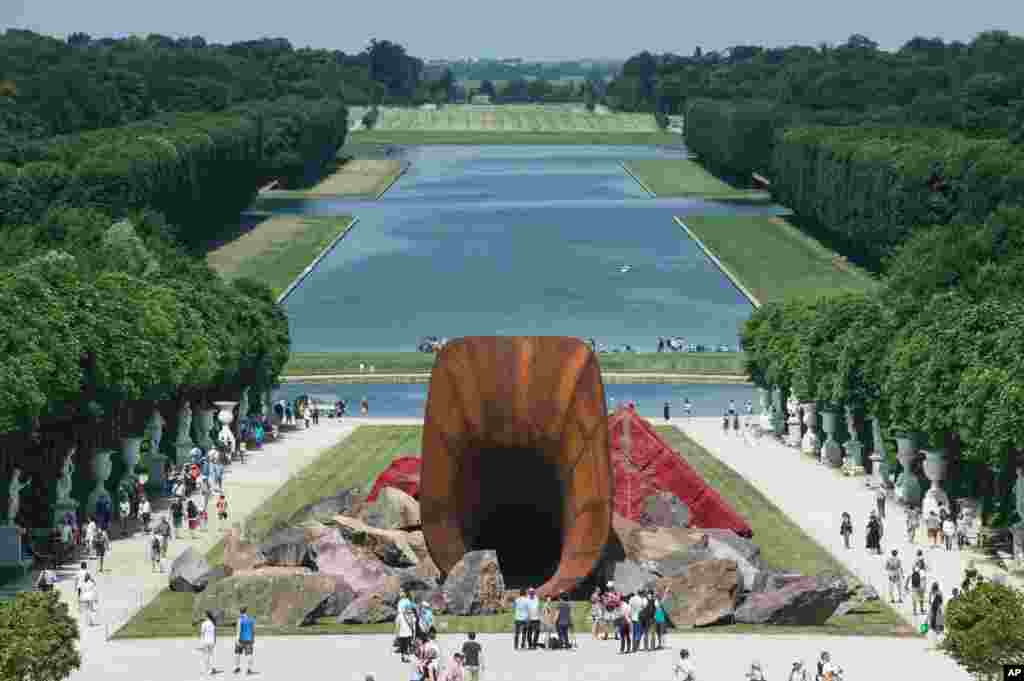 Visitors are walking alongside &quot;Dirty Corners&quot; by British artist Anish Kapoor in the gardens of the Chateau de Versailles outside Paris, France.