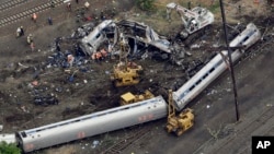 Emergency personnel work at the scene of a deadly Amtrak train derailment in Philadelphia, May 13, 2015.