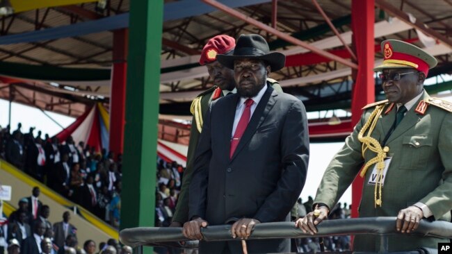 FILE - South Sudan's President Salva Kiir, center, accompanied by then-Army Chief of Staff Paul Malong, right, attends an independence day ceremony in the capital, Juba, July 9, 2015. 