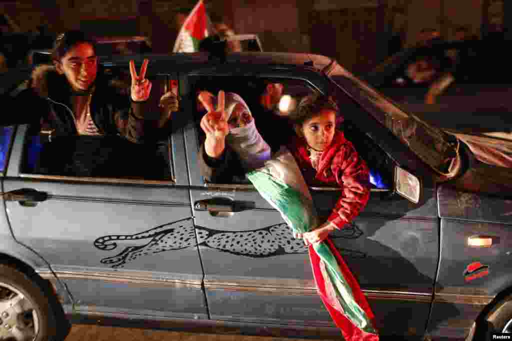 Palestinians celebrate on a street in Gaza City, November 30.