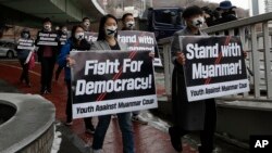 Members of youth group holding signs march toward the Myanmar embassy during a rally against the military coup and supporting Myanmar's democracy in Seoul, South Korea, Friday, Feb. 5, 2021.