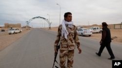 Pro-Gadhafi militiamen guard a checkpoint in Bin Jawad March 12, 2011