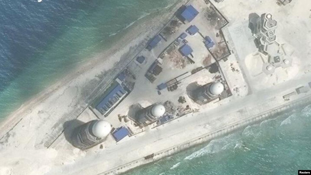 FILE - Construction is shown on Fiery Cross Reef, in the Spratly Islands, the disputed South China Sea in this March 9, 2017, satellite image released by CSIS Asia Maritime Transparency Initiative at the Center for Strategic and International Studies (CSIS).