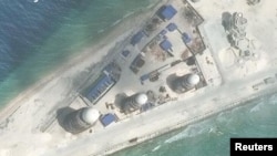 FILE - Construction is shown on Fiery Cross Reef, in the Spratly Islands, the disputed South China Sea in this March 9, 2017, satellite image released by CSIS Asia Maritime Transparency Initiative at the Center for Strategic and International Studies (CSIS).