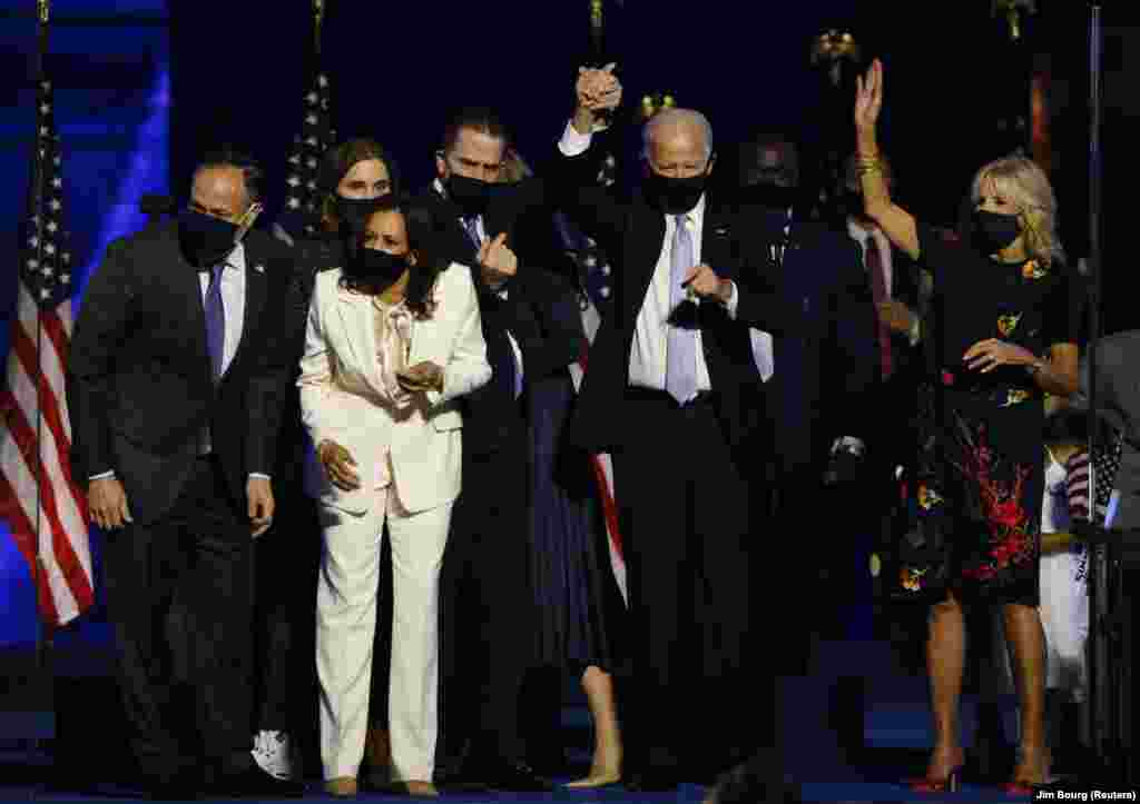 Democratic 2020 U.S. presidential nominee Joe Biden, vice presidential nominee Kamala Harris and their families celebrate onstage in Wilmington, Delaware, after the news media announced that Biden has won the 2020 U.S. presidential election, Nov. 7, 2020.