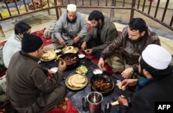 Pakistani customers eat grilled meat at the Charsi (Hashish) Tikka restaurant in Namak Mandi in Peshawar, Dec. 6, 2018.