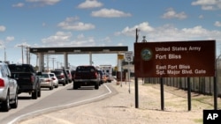 FILE - This Sept. 9, 2014 file photo shows cars waiting to enter Fort Bliss in El Paso, Texas. The base is one of three Texas military properties to be considered as a shelter location for unaccompanied migrant children.