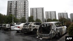 Burned cars are pictured at Froelunda Square in Gothenburg, Sweden on Aug. 14, 2018. 