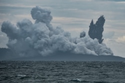 FILE - Mount Anak Krakatau volcano spews hot ash during an eruption as seen from Indonesian Naval Patrol Boat, KRI Torani 860, at Sunda Strait in Banten, Indonesia, Dec. 28, 2018.