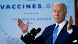 FILE - President Joe Biden speaks about COVID-19 vaccinations after touring a construction site for a Microsoft data center in Elk Grove Village, Illinois, Oct. 7, 2021.