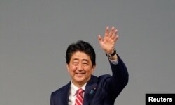 Japanese Prime Minister Shinzo Abe waves towards the delegates during the India-Japan Annual Summit, in Gandhinagar, India, September 14, 2017. REUTERS/Amit Dave