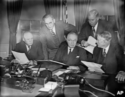 President Harry Truman checks the final draft of his “State of the Union” speech with congressional leaders two hours before going to the capitol to deliver it before a joint session of the senate and house, Jan. 8, 1951.