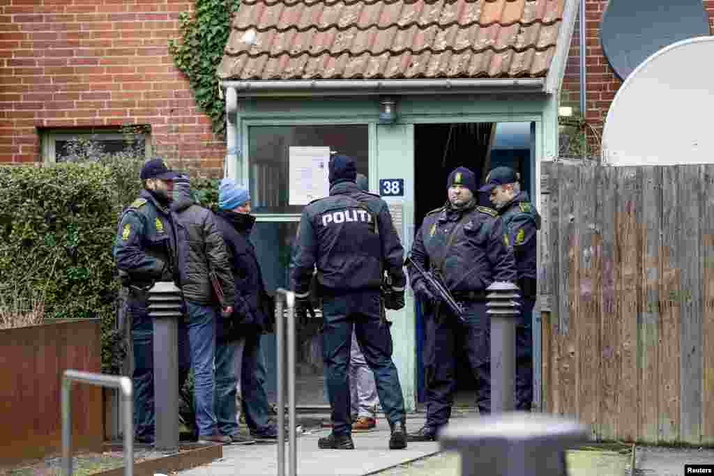 Danish police conduct a search at an apartment at Mjoelnerparken at Norrebro in connection with Saturday's shootings, Feb. 15, 2015.